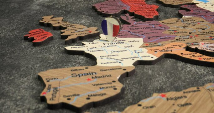 France - Travel concept with green pushpin on the world map. The location point on the map points to Paris, the capital of the France.