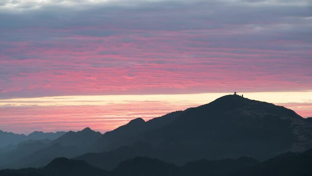 Stunning sunsets paint the sky pink and orange and frame the tranquil mountains. Warm winter mountain scenery in northern Taiwan, Shuangxi Buyanting Pavilion.