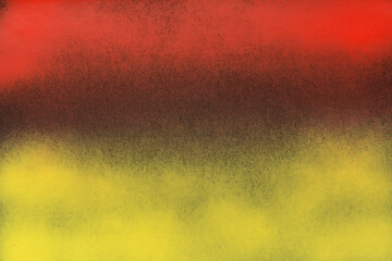 red and yellow spray paint on a black color paper background