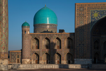 View of Tillya-Kari Madrasah and domed mosque building in the northern part of Registan Square on a sunny day, Samarkand, Uzbekistan