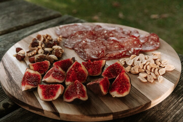 figs and meat on a board