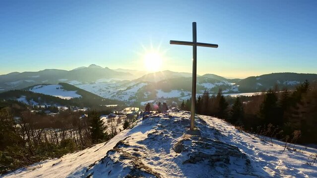 Panorama of winter nature sunset with cross in snowy hill foreground,Religious Christian background