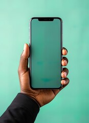 hand holding a smartphone mockup on green background. Smartphone with green screen background.