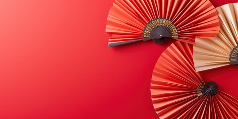 Chinese new year festival or wedding decoration over red background. Traditional lunar new year paper fans. Flat lay, top view, banner.