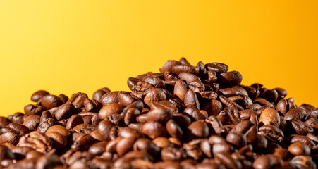 Coffee beans on vibrant orange gradient background with copy space for text