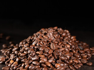 Rustic style roasted coffee beans on dark background - low key photography