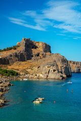 The Acropolis of Lindos and the beach in St. Paul's Bay in Rhodes.