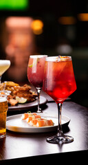Dinner banquet table paired with salmon and branded fruits in restaurant and red cocktail glass in focus aperol spritz beer