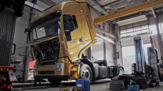 Automatic lifting of the pneumatic cab of a new truck at the factory producing trucks. Timelapse