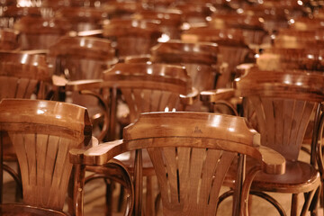wooden chairs lined up in the interior