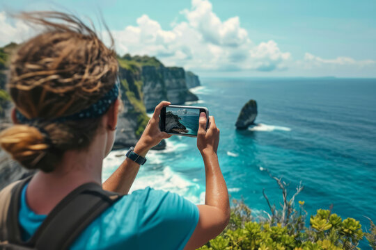 Travel content creator using mobile phone to capture images and videos