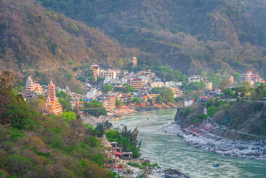 Panoramic cityscape of Rishikesh city, also known as yoga capital of World located along foothills Himalayas along banks of river Ganga or Ganges in Uttarakhand state of India.