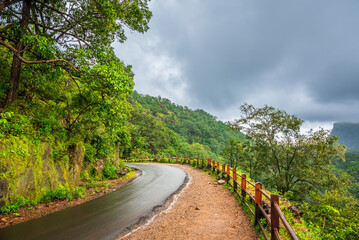 Panoramic view of Pachmarhi valley having clouds and mist shrouded hills rolling on each other from Chaudeshwar Mahadev Temple road in Pachmarchi, Madhya Pradesh, India.