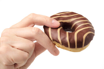 Human hand holding striped chocolate and caramel donut