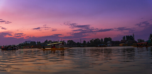 View of Dal Lake during sunset and the beautiful mountain range in the background in the city of...