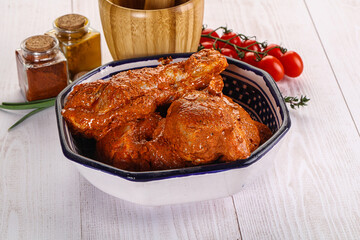 Raw turkey shoulder wing in Indian tandoori marinade