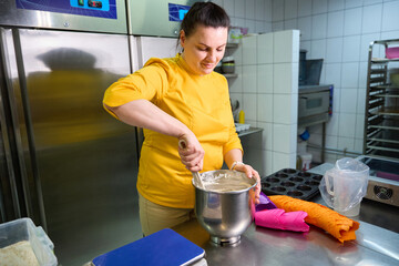 Experienced pastry chef is making batter for cupcakes