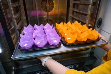 Experienced pastry chef baking batch of muffins