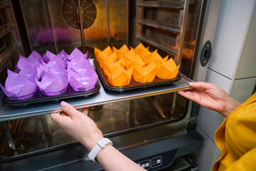 Experienced baker is baking batch of cupcakes