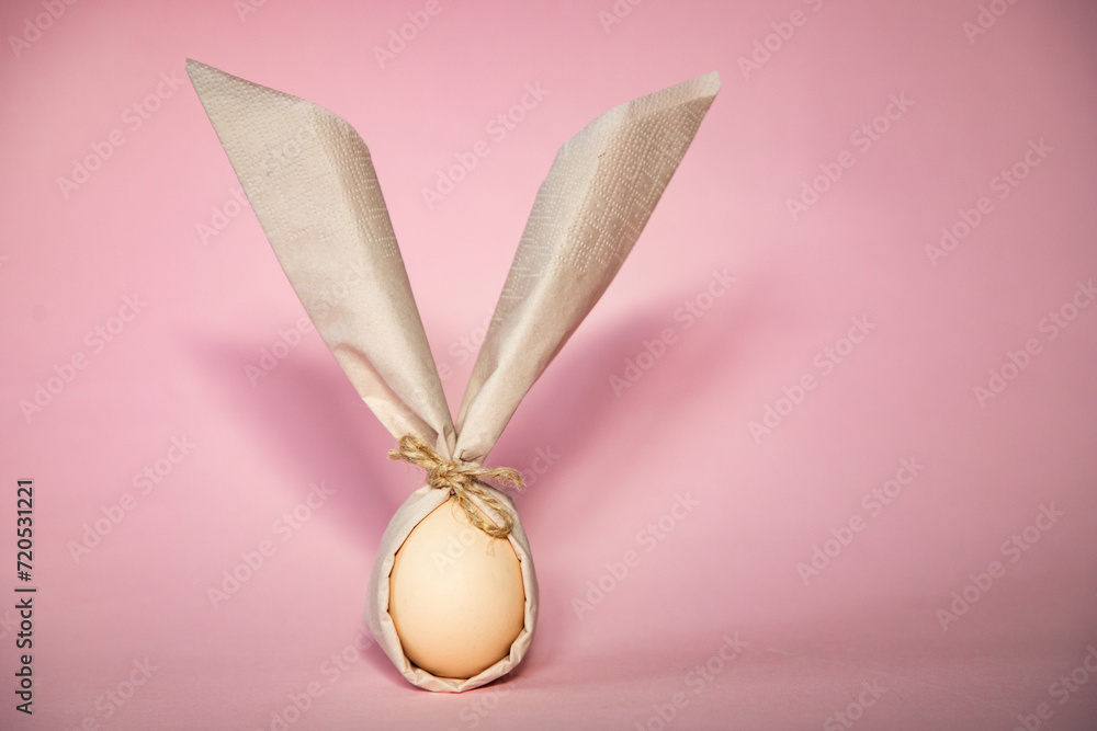 Wall mural egg wrapped in easter bunny shaped napkin