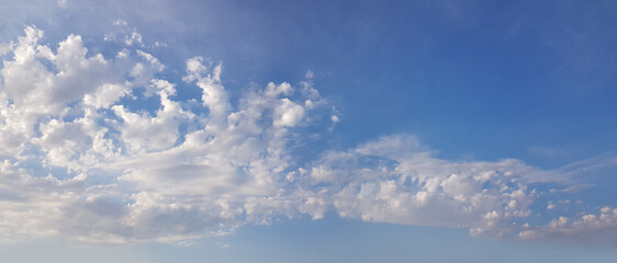 Naklejka na ściany i meble Blue sky with fluffy white cloud, weather background