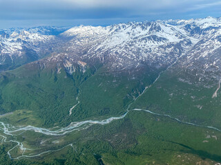 Lake Clark National Park and Preserve in Alaska. Braided alpine rivers full of snowmelt. Aerial view over rugged and remote mountains. 