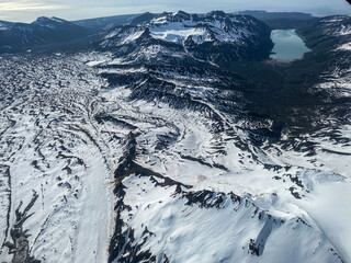 Hickerson Lake at Lake Clark National Park in Alaska. Chinitna Bay in the Cook Inlet, foot of Mount Iliamna. Aerial view of rugged and remote mountains, glaciers, lakes and rivers.