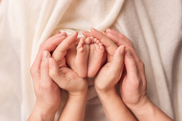 Children's legs in the hands of parents. Children's legs on a white background.