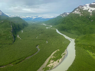 Johnson River and Johnson River Basin at Lake Clark National Park in Alaska. Aerial view of glacial river flows from Mount Iliamna Volcano glaciers, near Slope Mountain and towards Cook Inlet.