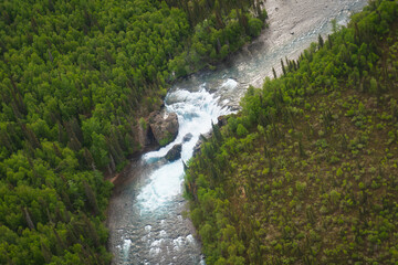 Fototapeta na wymiar Lake Clark National Park in Alaska. Tanalian Falls and Tanalian Mountain and river. Aerial view of spruce trees, rugged mountains and popular day hike area near Port Alsworth.