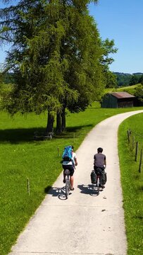 Cyclists on a Cycling Path Through the Allgäu Region in Bavaria, Germany