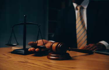 Judge gavel with Justice lawyers having team meeting at law firm background. Concepts of Law and...