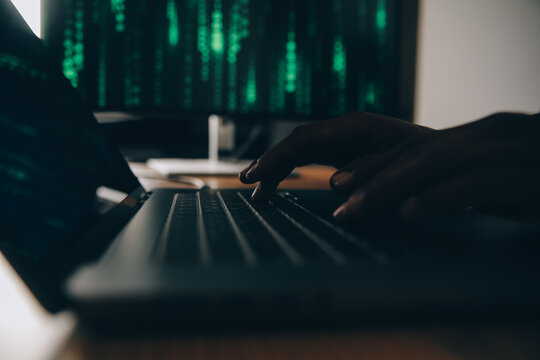 Hacker code in laptop. Cyber security, privacy or hack threat. Coder or programmer writing virus software, malware, internet attack or developing digital design. Green web data in computer screen.