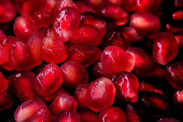 Wet seeds, pomegranate berries in macro photography