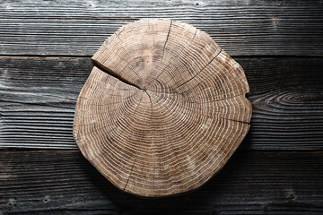 Wooden plate carved from tree trunk on old grunge wooden table. Can be used like natural textured...