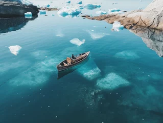 Rucksack aerial view of canoe floating in calm clear water with icebergs in Greenland in daylight  © Johannes