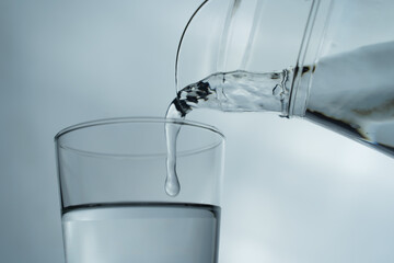 Filling a glass with water showing a drink concept. bubbles in fresh water with white background. 
