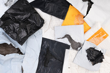 Torn plastic parcel bags isolated on white background. View from above. Open package.
