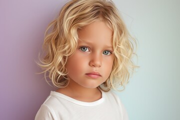 A little boy With Blonde Hair and Blue Eyes looking at the camera, 
