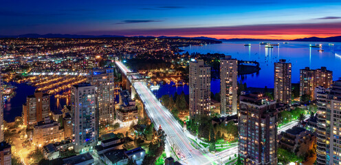 Downtown Vancouver Cityscape on West Coast of Pacific Ocean. Night after Sunset. Aerial Panorama