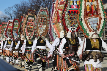 Pernik, Bulgaria - January 26, 2024: International masquerade festival Surva in Pernik, Bulgaria. People with mask called Kukeri dance and perform to scare the evil spirits.