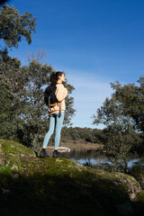 Naklejka premium Woman hiking in nature alone with her backpack