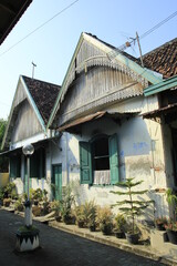 Classic building facade of a house with an open window in Kauman village, Yogyakarta.