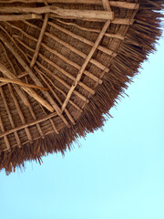 Grass thatch umbrella shade on a beach