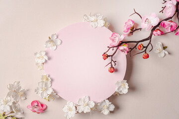 Fototapeta na wymiar Decorative podium with pink cherry flowers on pastel pink background, top view, flat lay. Place for product presentation. Creative product platform
