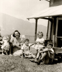 ANCIENT PHOTO WITH A MOTHER AND HER LITTLE CHILDREN ON THE MEADOW