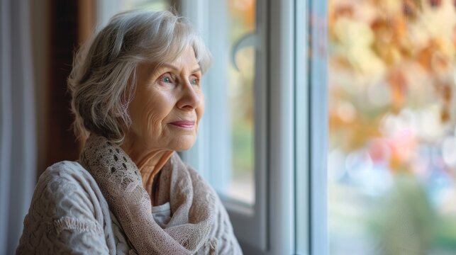 old senior woman contemplative  looking out of the window