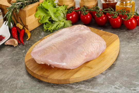 Raw chicken breast with skin