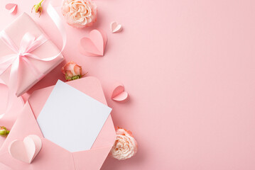 Glamorous Greetings: Elevate your Women's Day wishes for fashion-forward partner. Top view of envelope, beautifully wrapped gift box, lovely rosebuds, artfully arranged hearts on pastel pink canvas