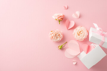 Cherish your chic love! Capture the moment with an overhead view of a giftbox filled with beautiful rosebuds and hearts on a pastel pink setting. Personalize the space with text or promotions - obrazy, fototapety, plakaty